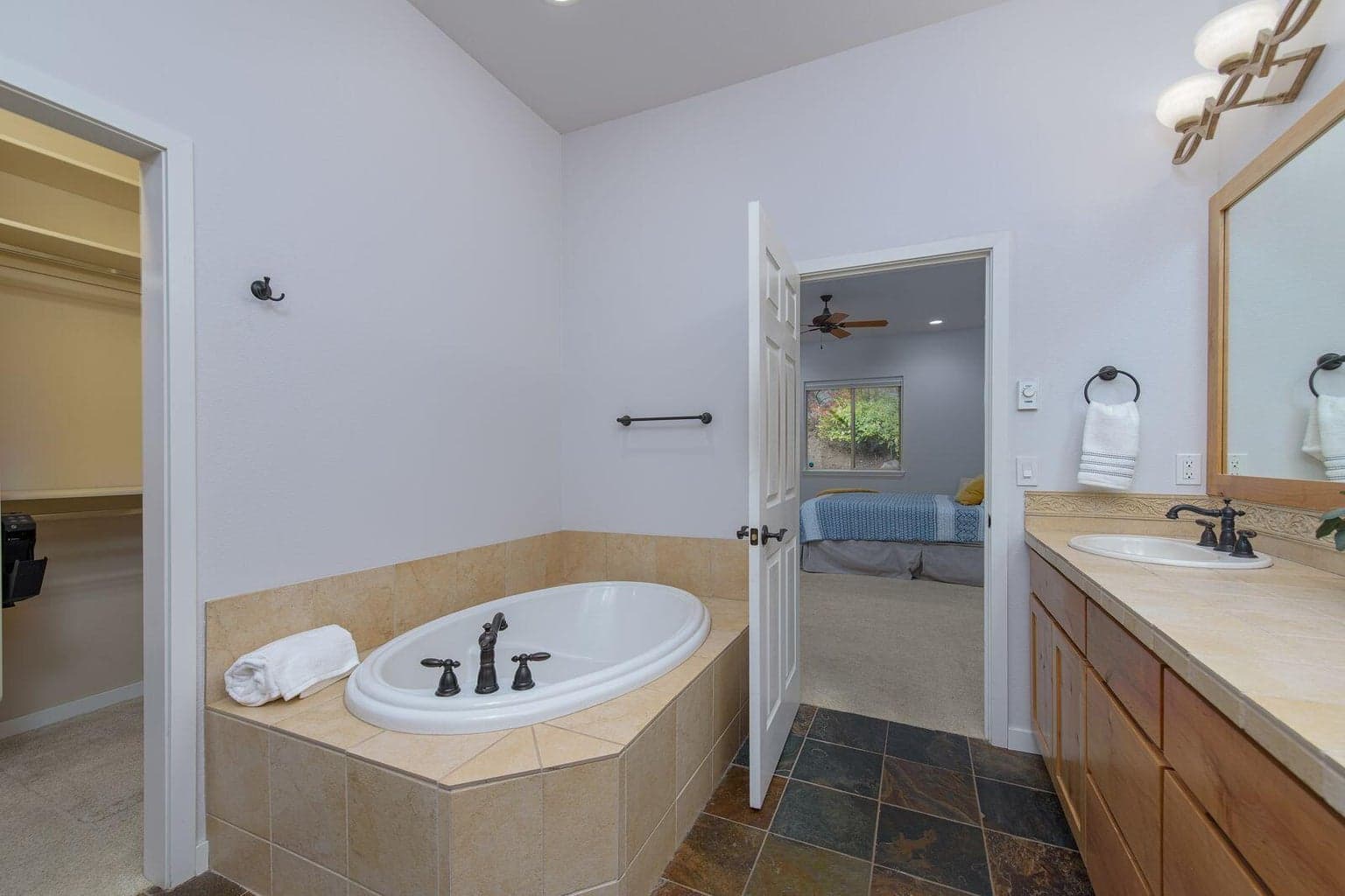 Stone floors, soaking tub and walk in closet
