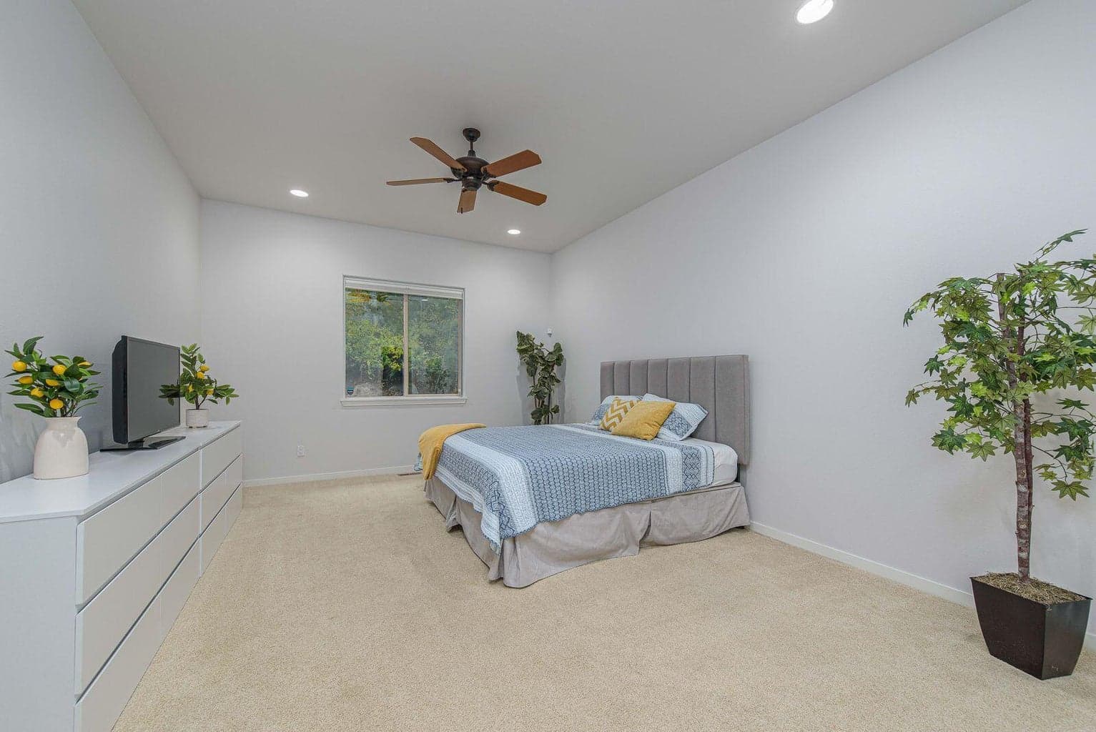 Large primary bedroom with a ceiling fan