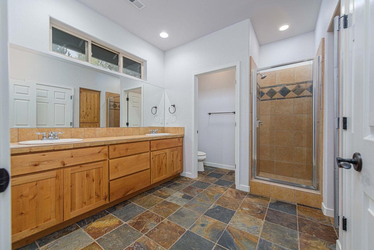 Large bathroom with walk in shower, there is a door to this bathroom from the bedroom as well as from the loft area