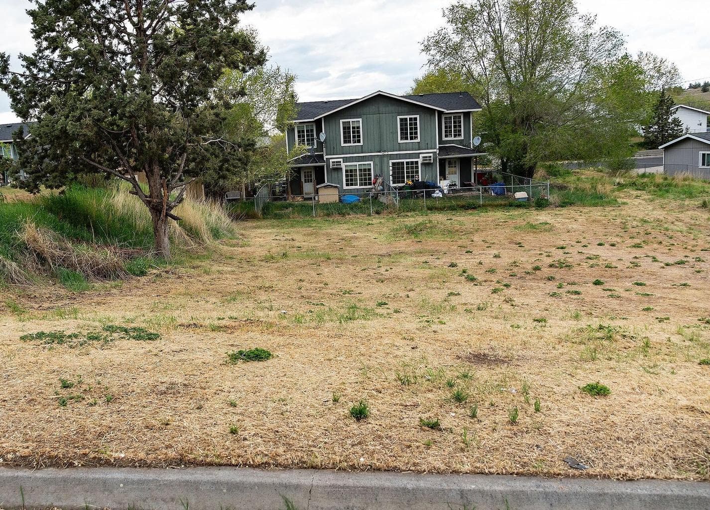 The streets in this neighborhood are already paved and have the curbs installed.