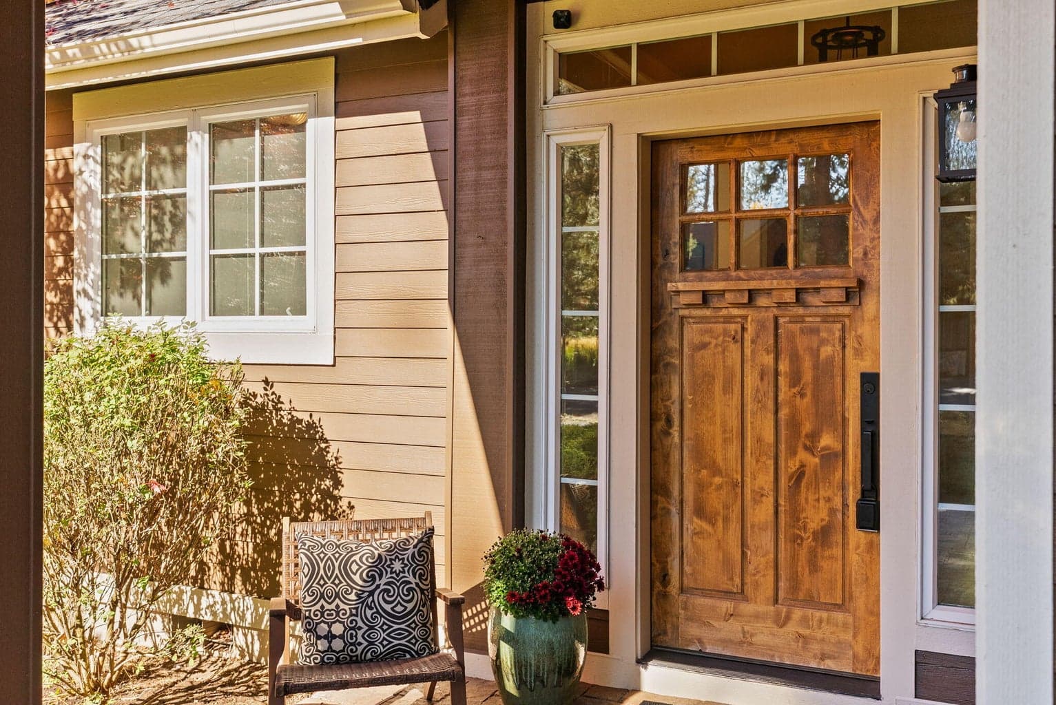 Covered front entrance with transom and side lights around front door