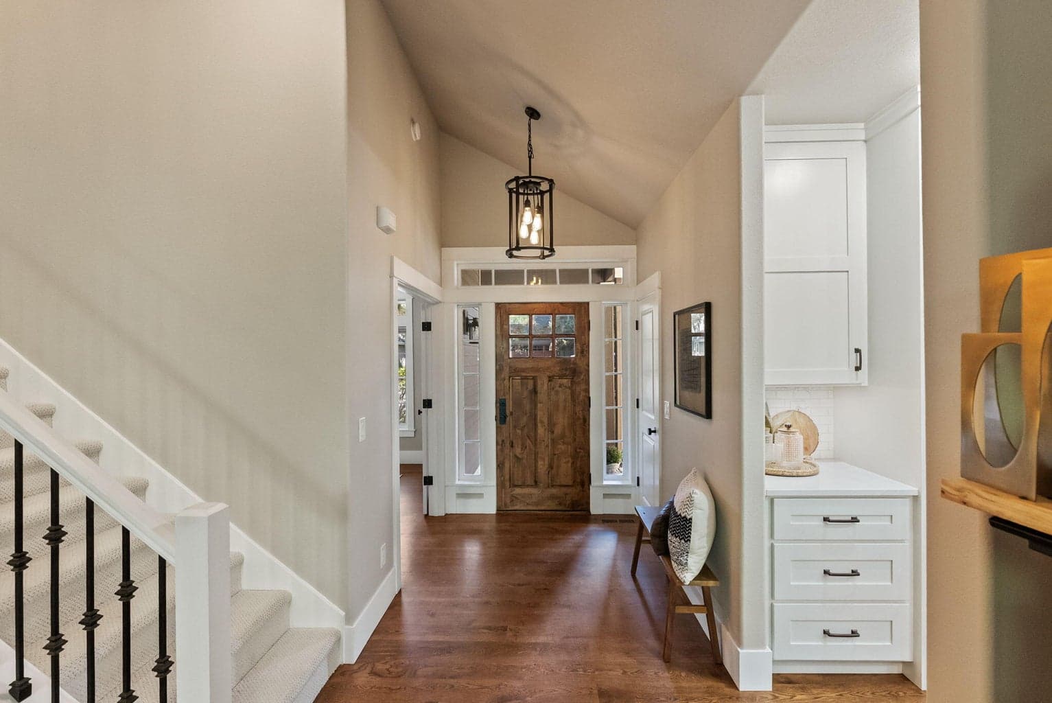 Front entrance into hallway leading to office, kitchen, and great room