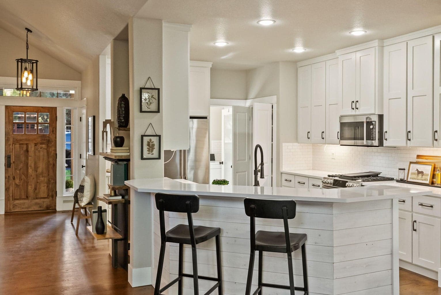 Chef's kitchen with quartz slab countertops, farmhouse sink, pantry cupboard, under cabinet lighting, GE Cafe appliances, propane range, and more!