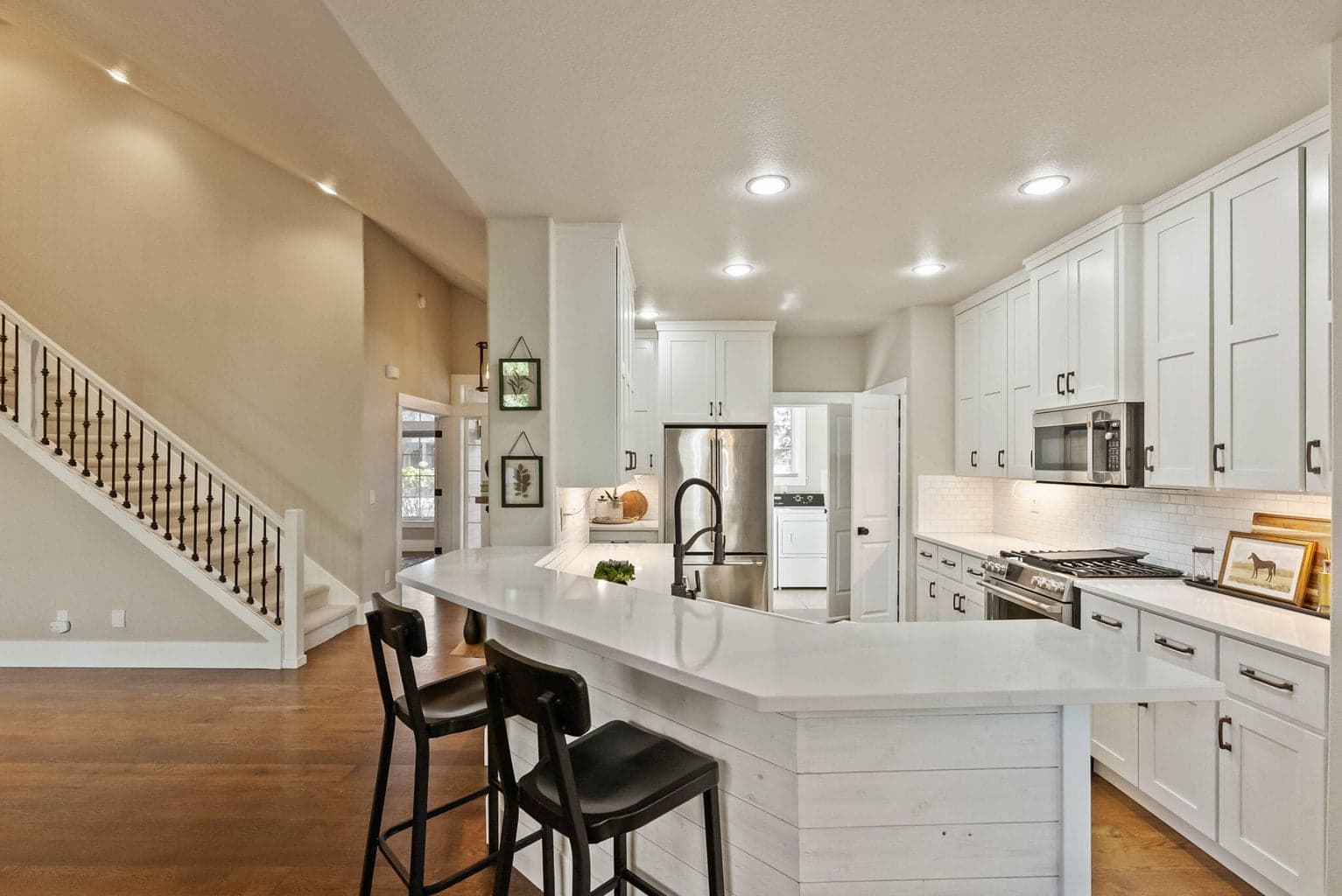 Chef's kitchen with quartz slab countertops, farmhouse sink, pantry cupboard, under cabinet lighting, GE Cafe appliances, propane range, and more!