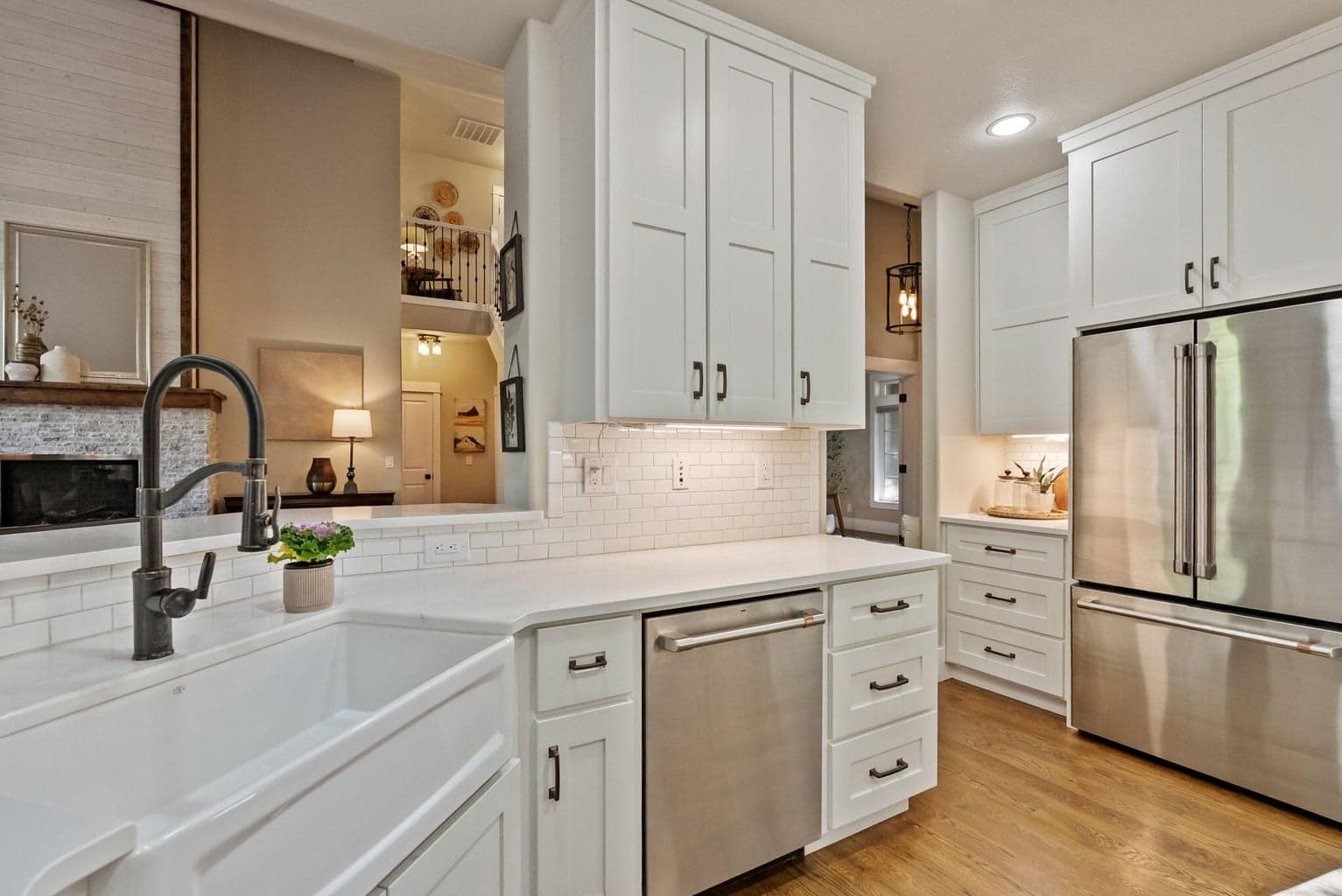 Chef's kitchen with quartz slab countertops, farmhouse sink, pantry cupboard, under cabinet lighting, GE Cafe appliances, propane range, and more!