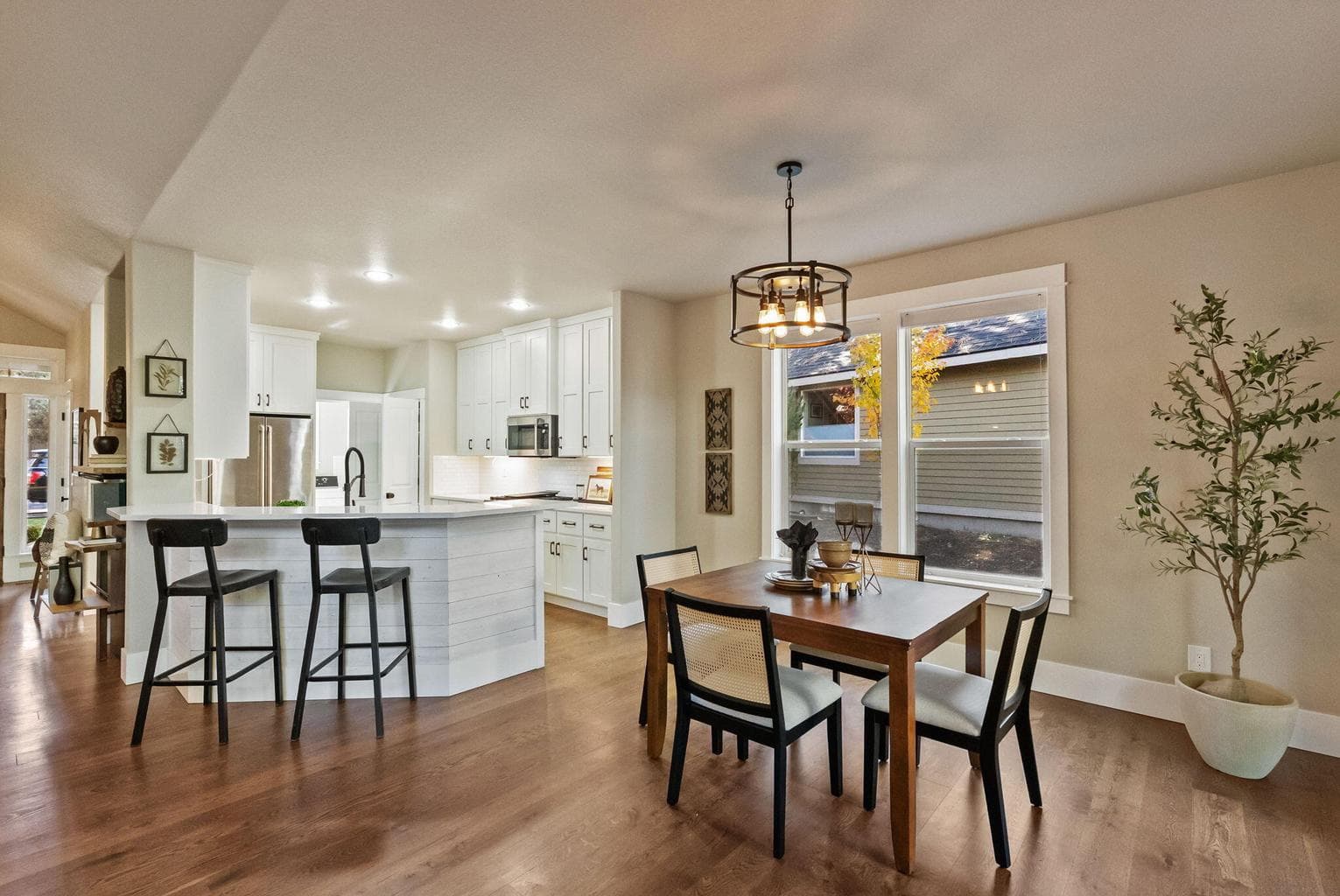 Great room with chef's kitchen, breakfast bar seats 4, and dining area