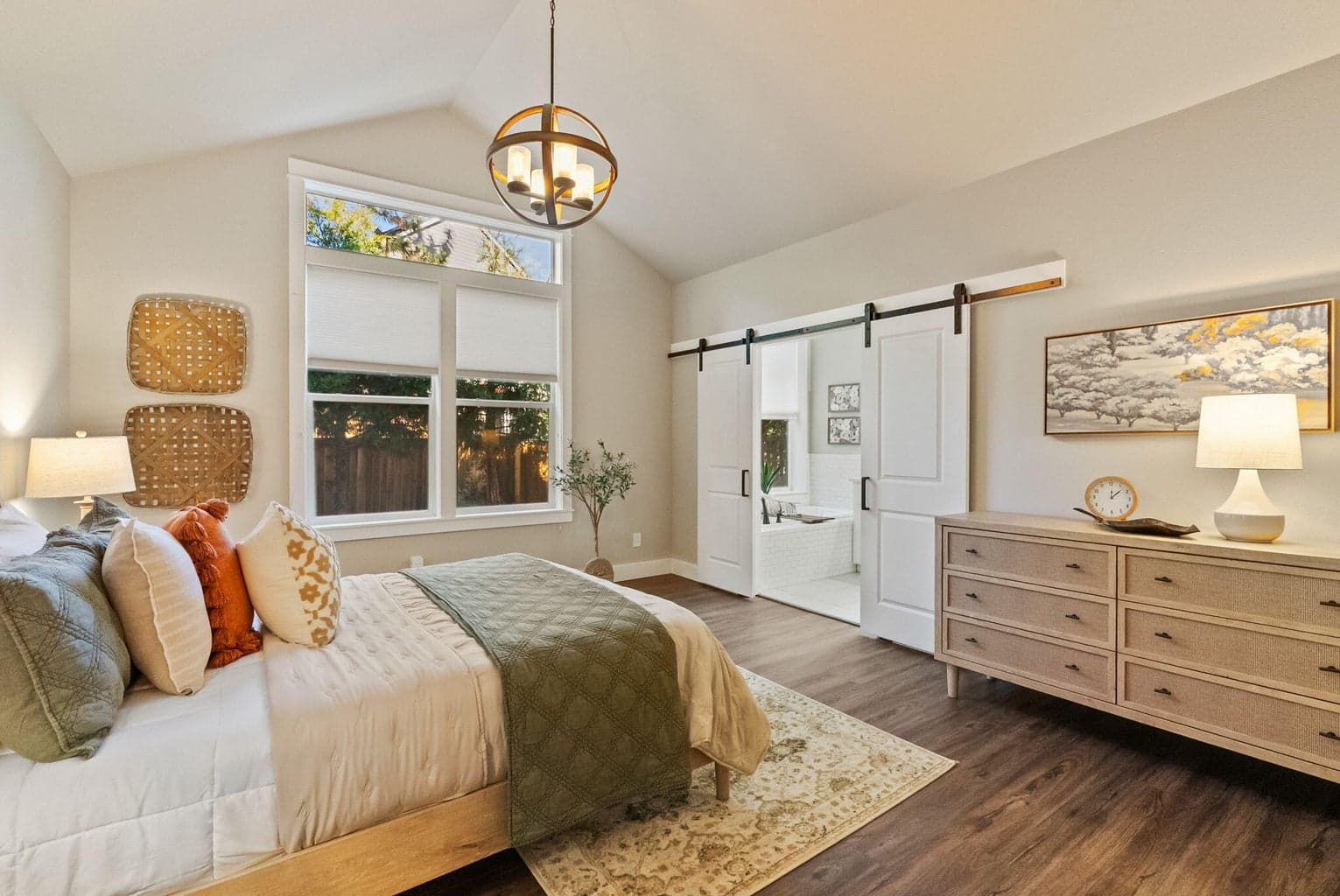 Primary suite on main level with new laminate floors, walk-in closet, barn doors to ensuite bath