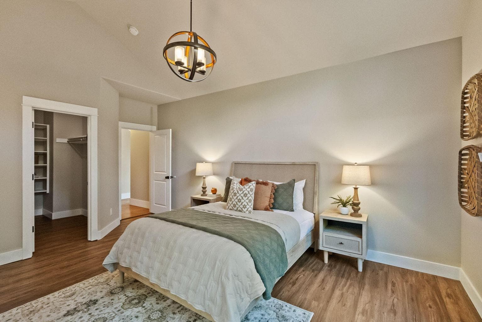 Primary suite on main level with new laminate floors, walk-in closet, barn doors to ensuite bath