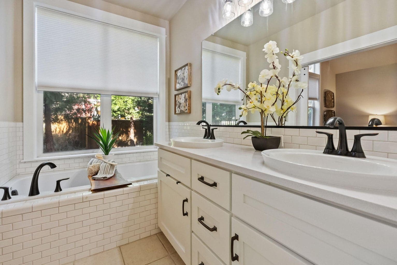 Primary ensuite bath with soaking tub, double sinks, commode room with shower