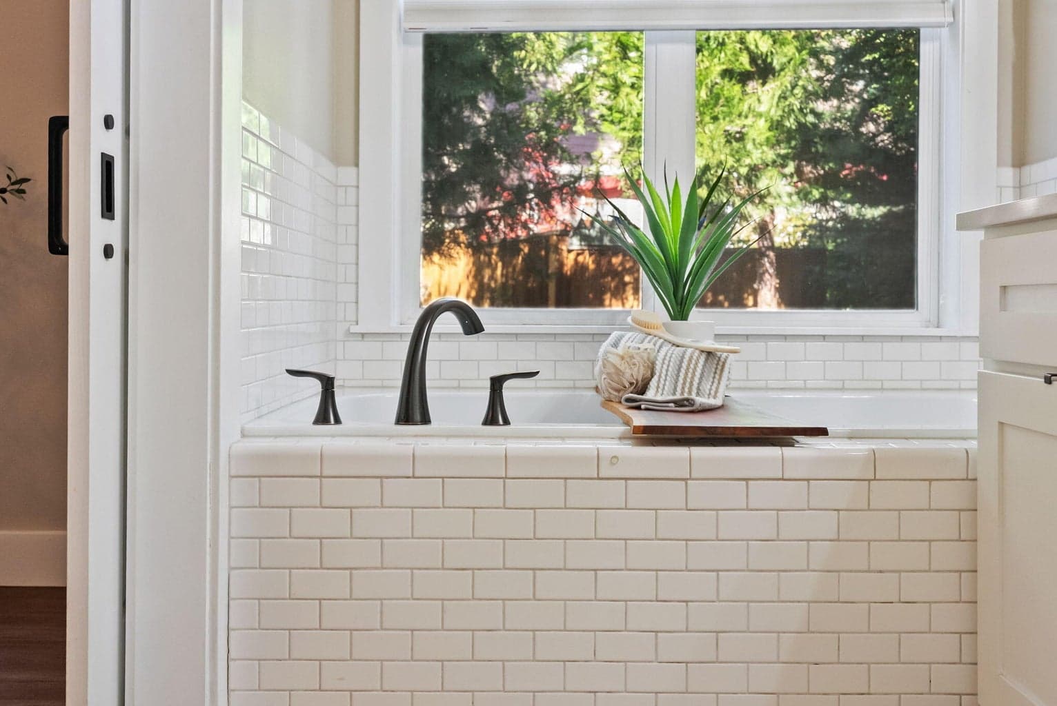Primary ensuite bath with soaking tub, double sinks, commode room with shower