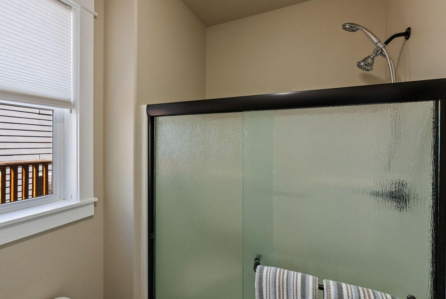 Primary ensuite bath with soaking tub, double sinks, commode room with shower