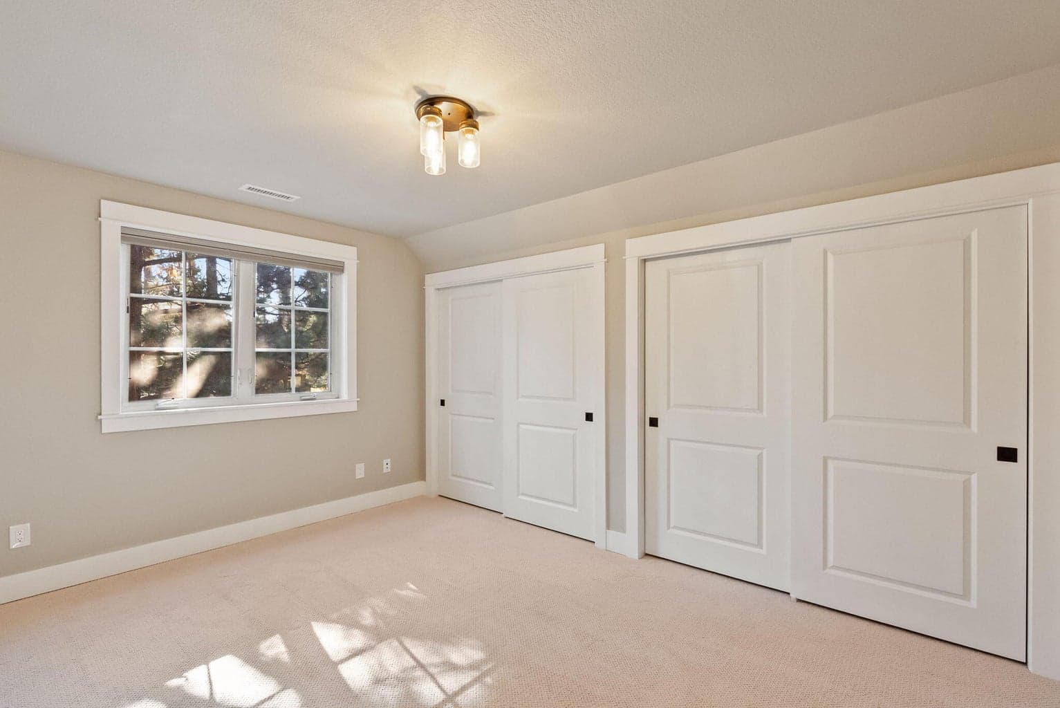 Upstairs Bedroom 2 accommodates a queen bed underneath the window plus additional seating/reading/play area