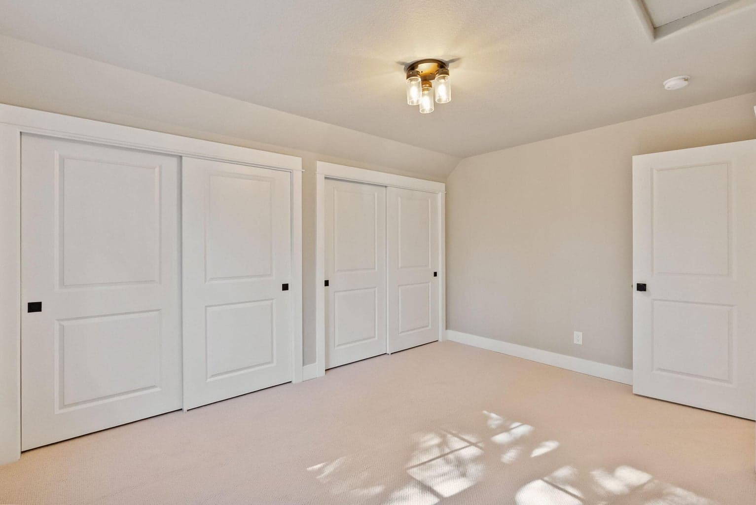 Upstairs Bedroom 2 accommodates a queen bed underneath the window plus additional seating/reading/play area