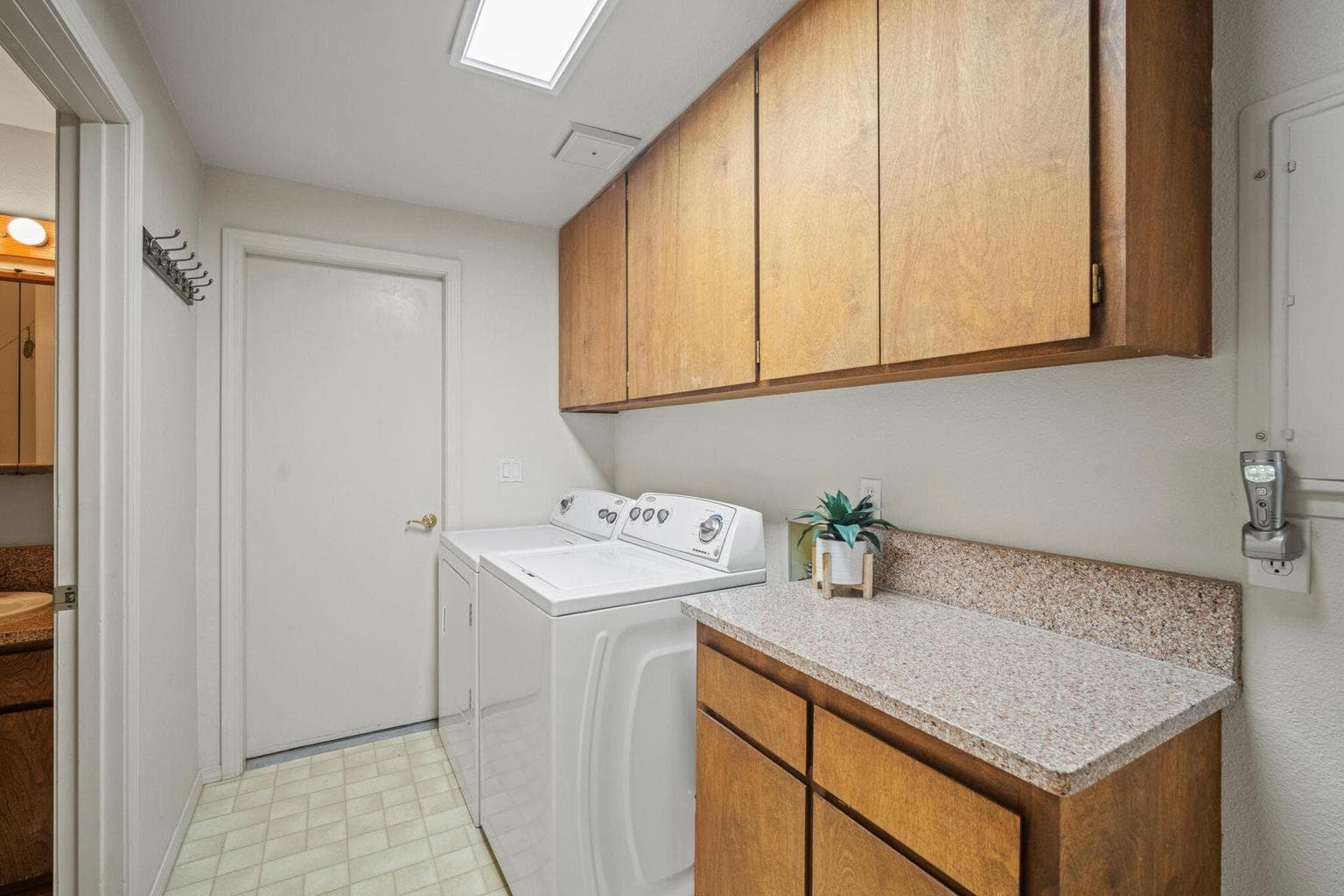 Laundry room with lots of storage and door out to attached garage.