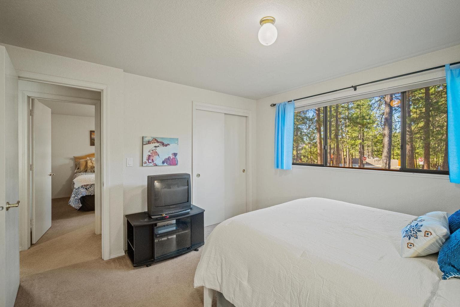 Main Level Bedroom featuring closet and large window.