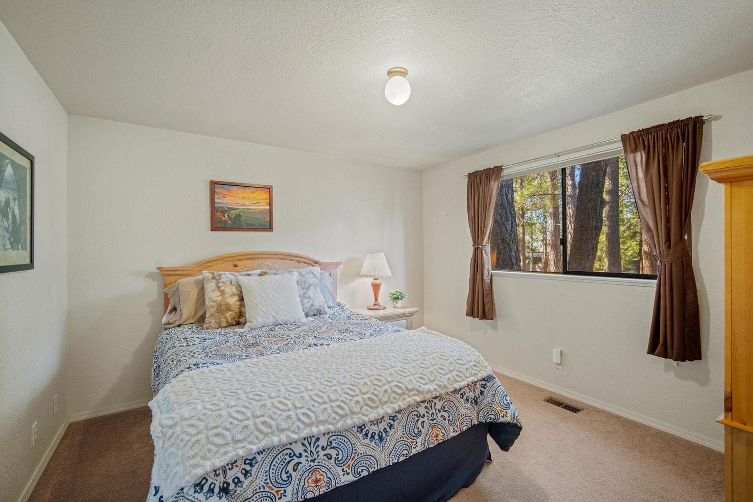 Main Level Bedroom 2 and large window to the outdoors.