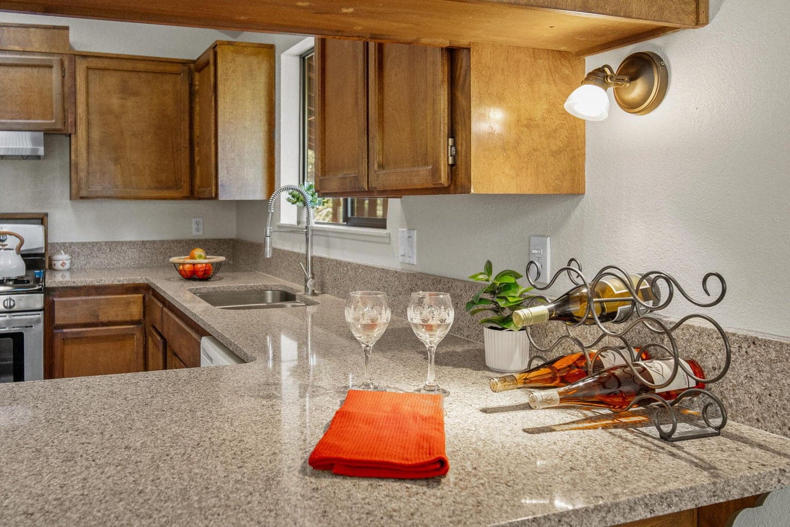 Granite countertops, breakfast bar and stainless steel appliances in the kitchen.