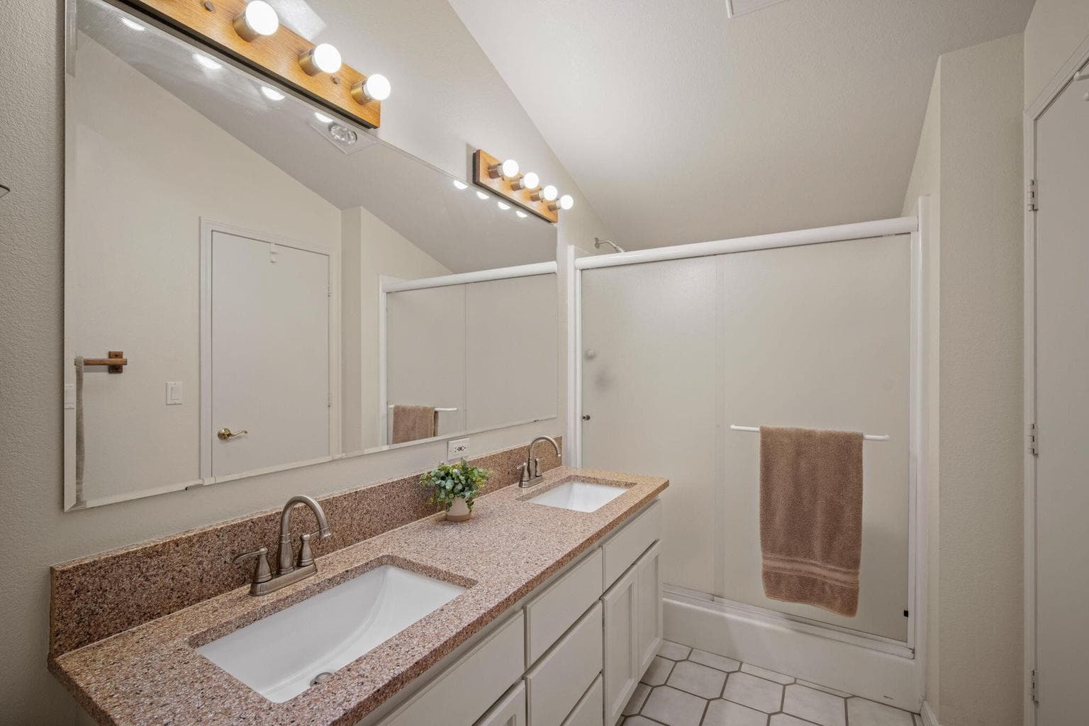 Large primary bath with a flexible door that can be accessed from the hallway for guests.