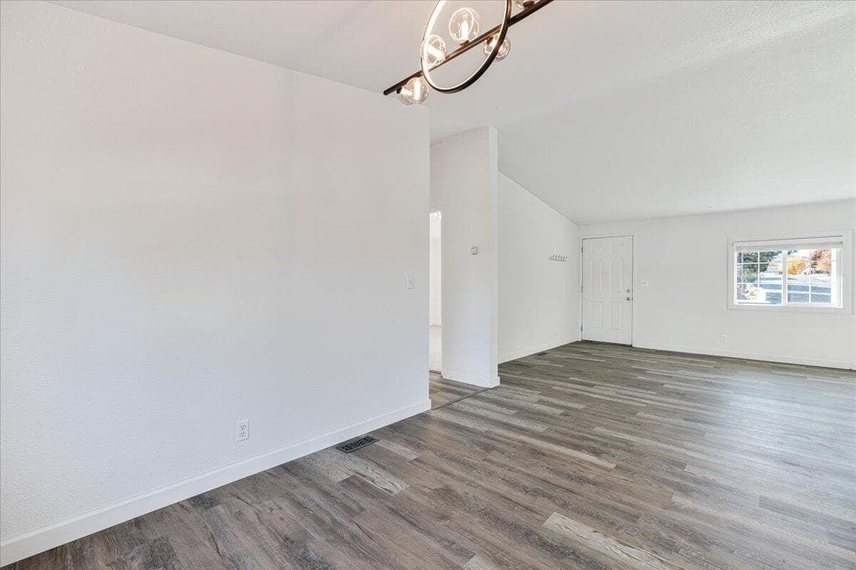Dining room view to secondary bedrooms and front entry.