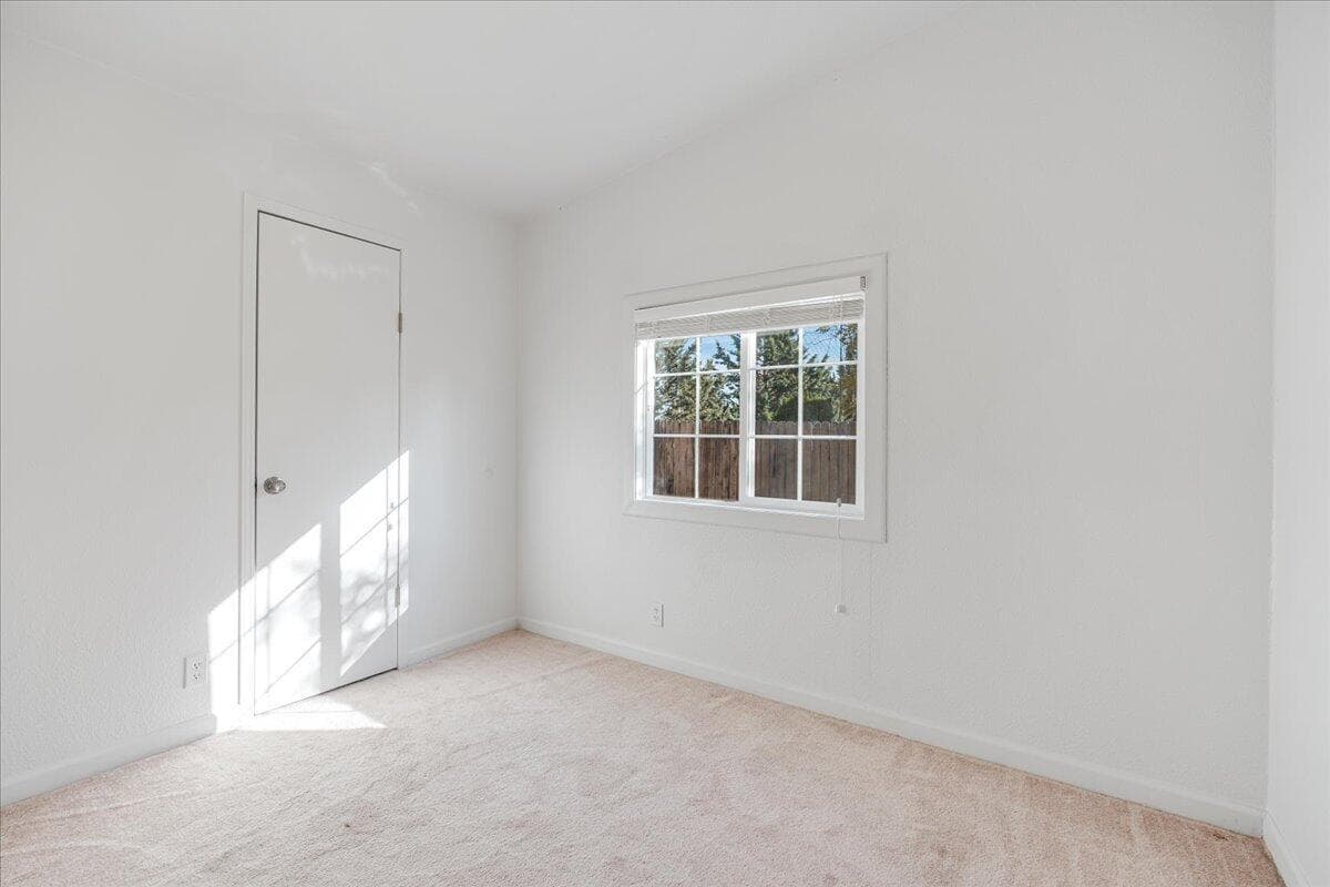 smaller secondary bedroom with walk-in closet