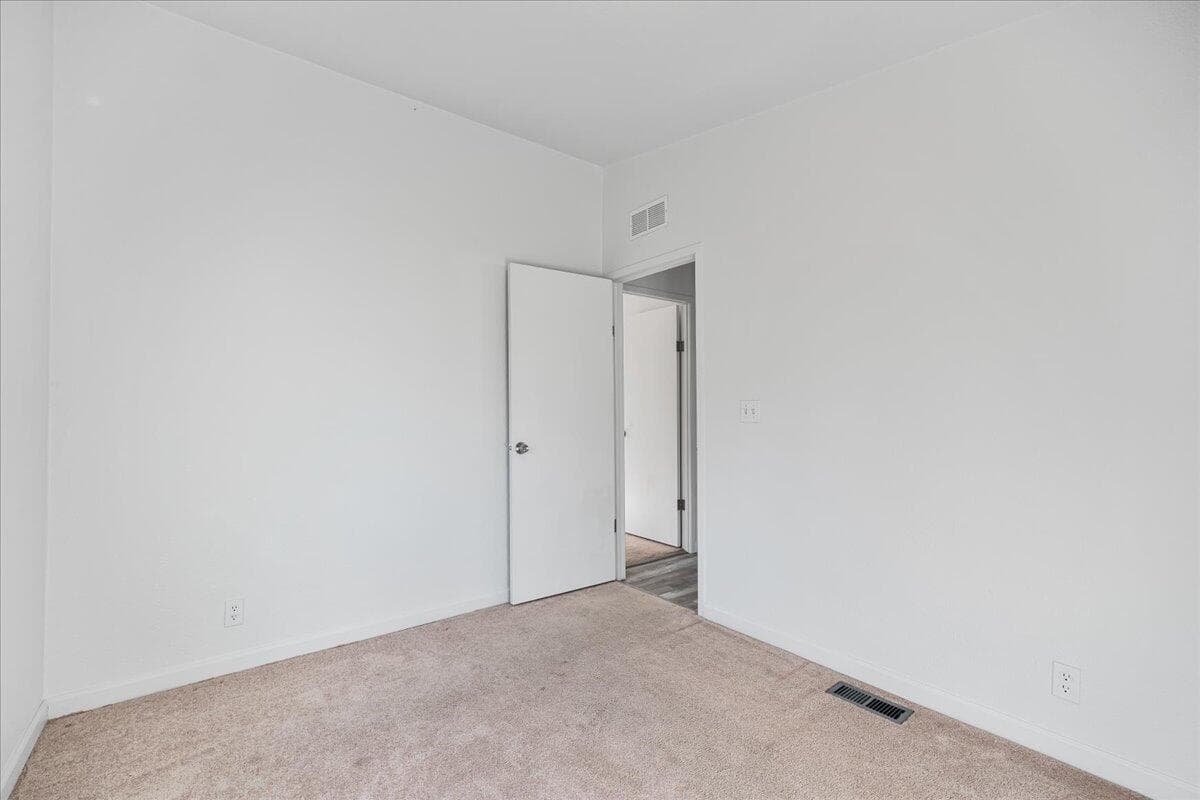 smaller secondary bedroom view to hallway