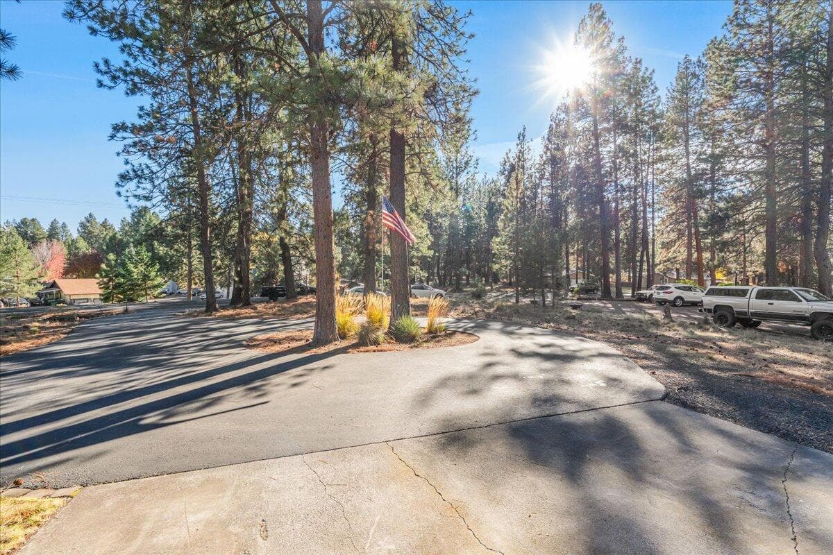 Long asphalt circular driveway, setting the home far back from the road