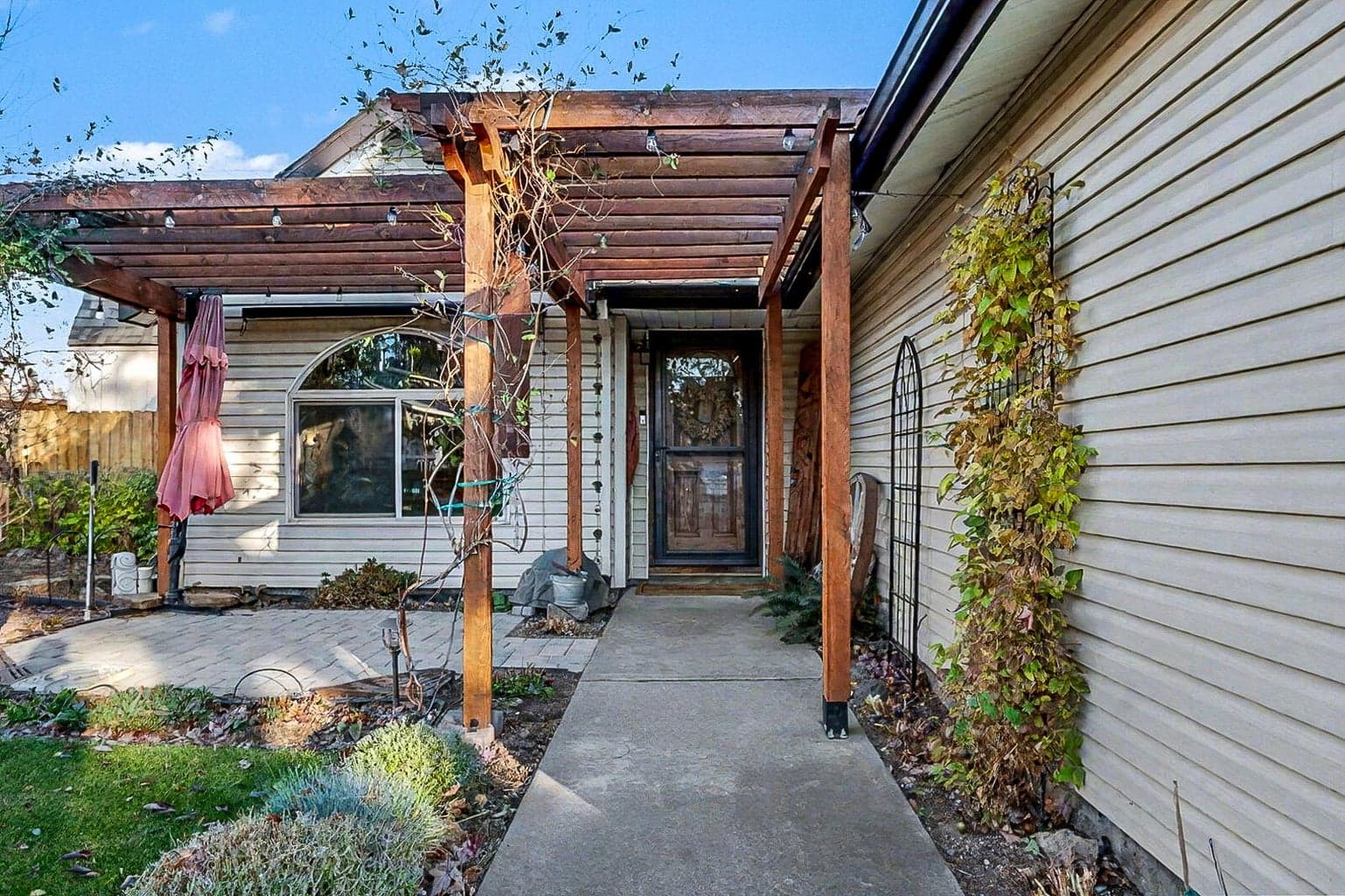Patio and flower gardens at entrance to home