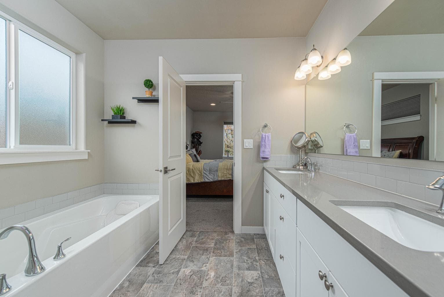 Primary bathroom with soaking tub and tile shower