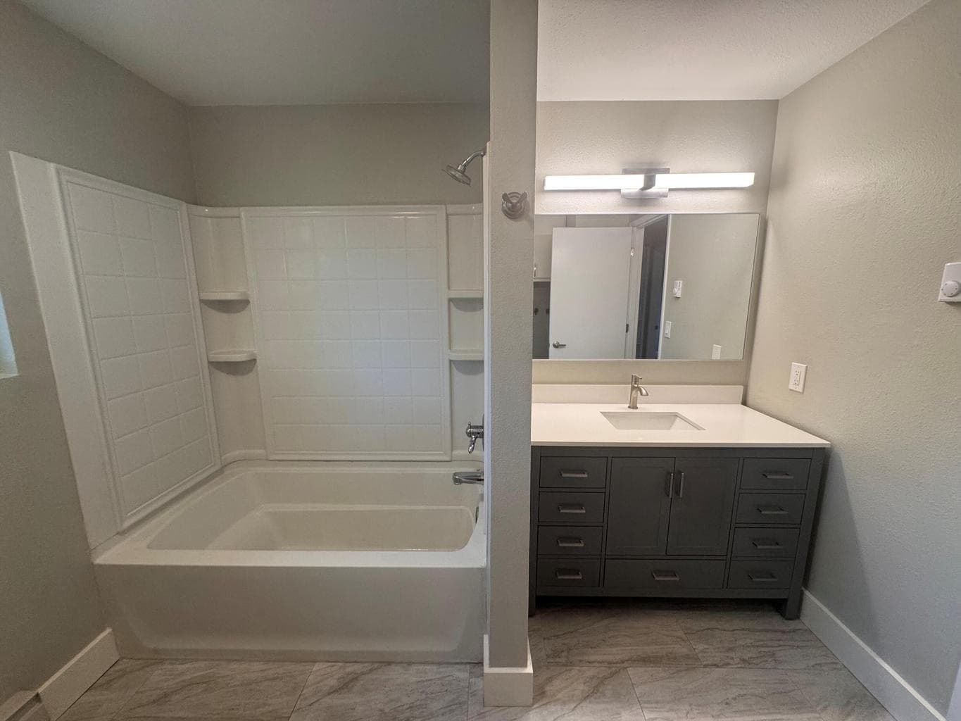 New tile floors, vanity, lighting.