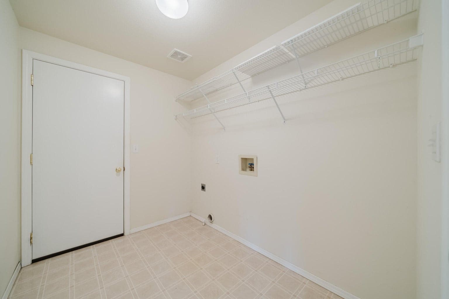 Laundry Room and entrance to the 3 car garage.