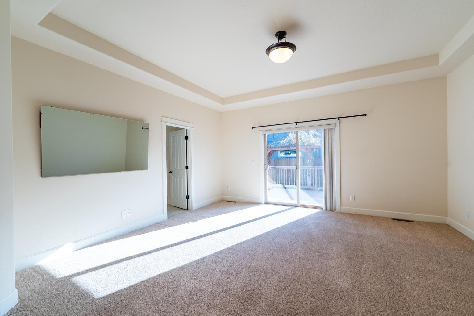 Primary bedroom suite with access to deck in back yard