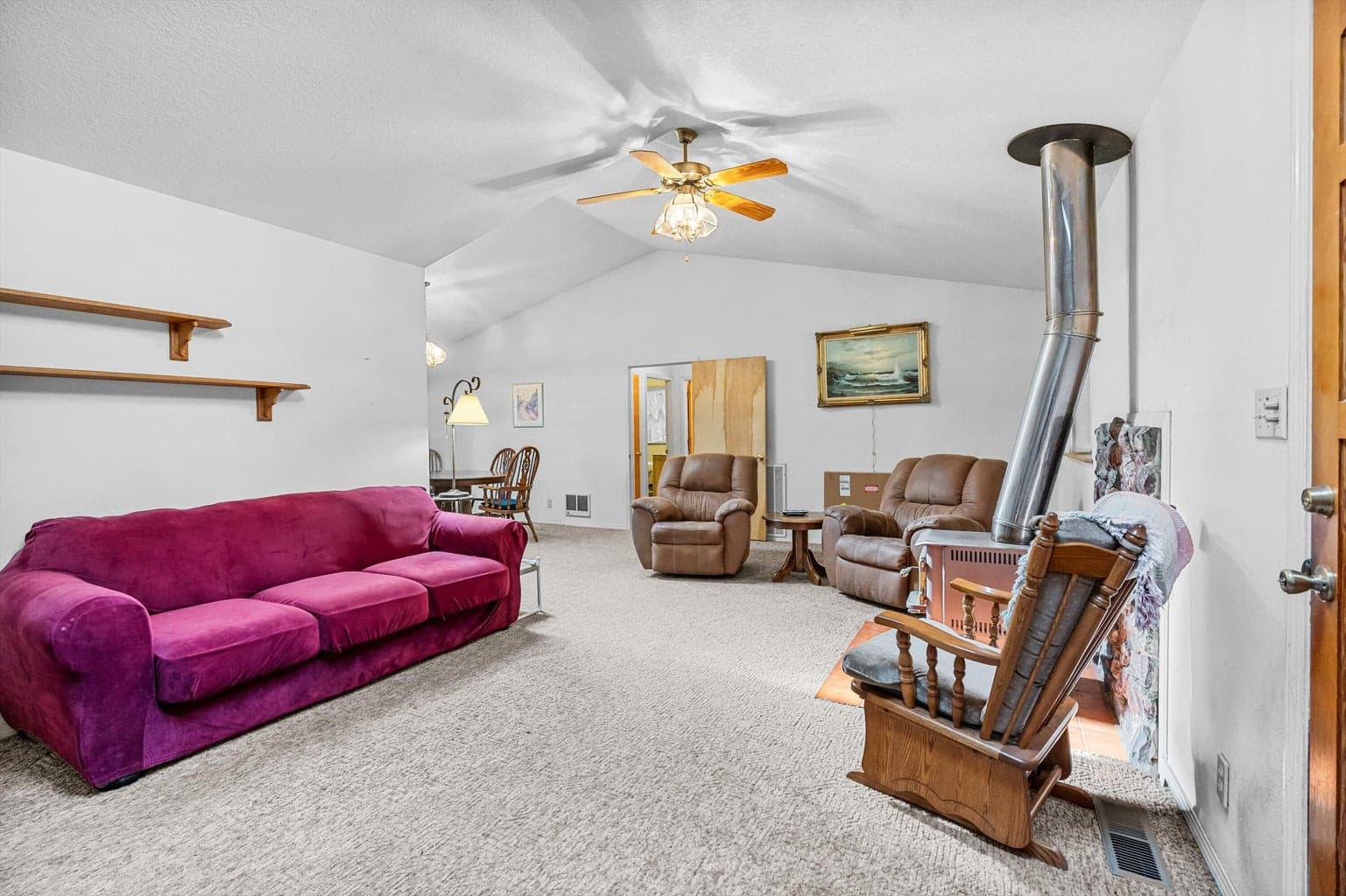 Living room with wood stove and high ceilings