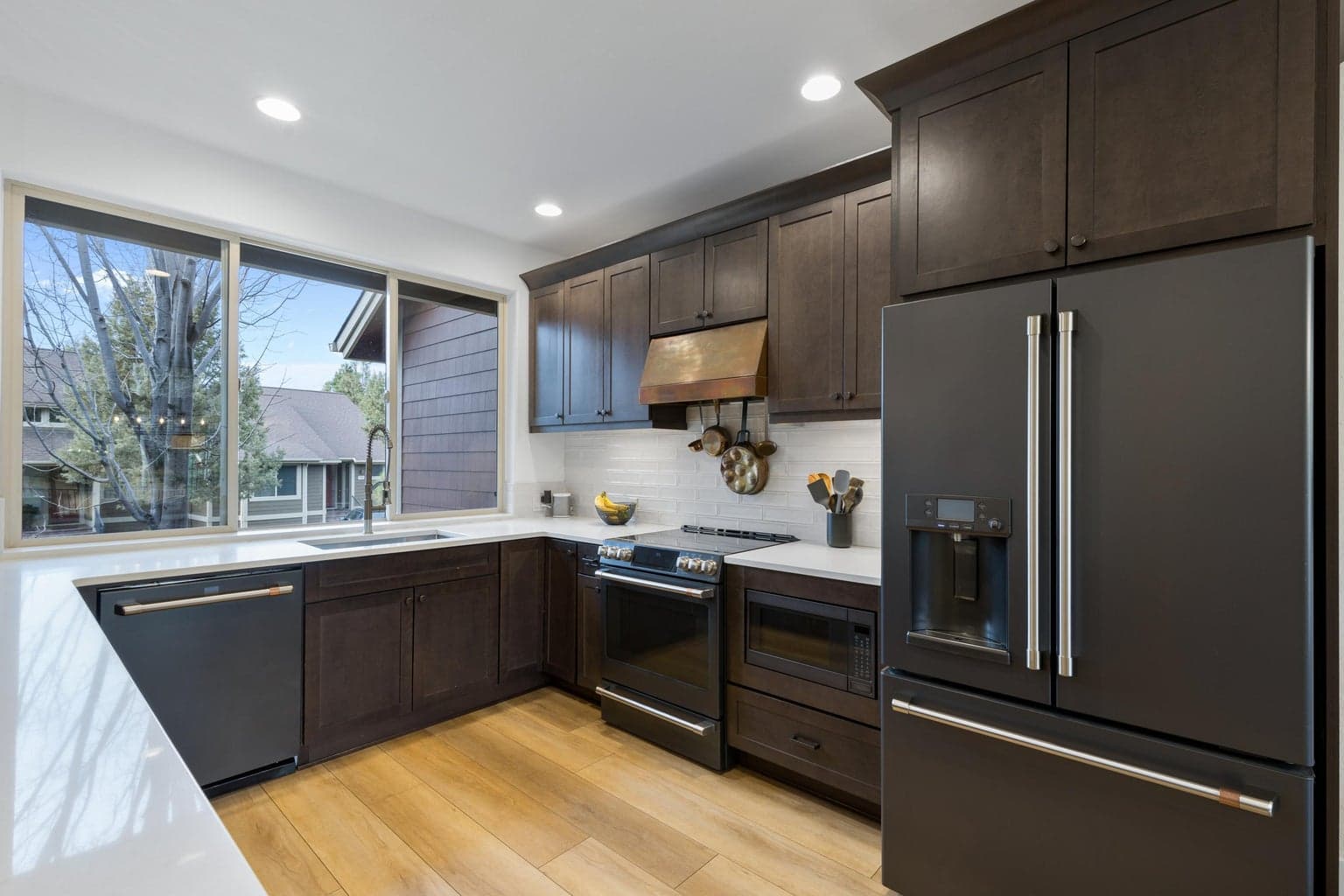 Enjoy new high-end appliances and a gorgeous custom copper range hood.