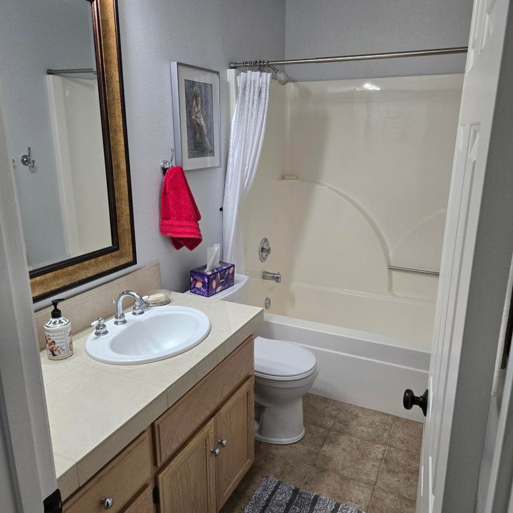 Guest bathroom with fiberglass tub-shower