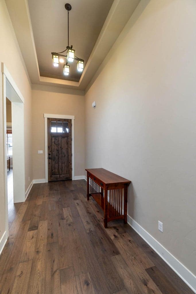 Entry from front door. Coffered ceiling. Upgrades solid stained front door.