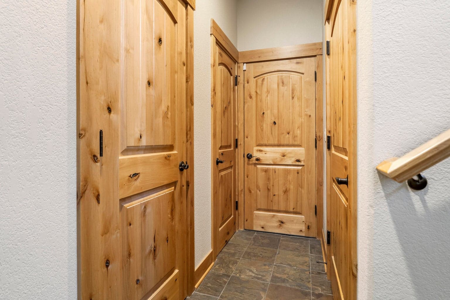 Hall to wine room, storage closets, door to garage.