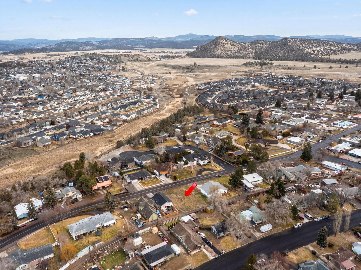 Wide aerial view showing the neighborhood's proximity to local mountains and ridges.