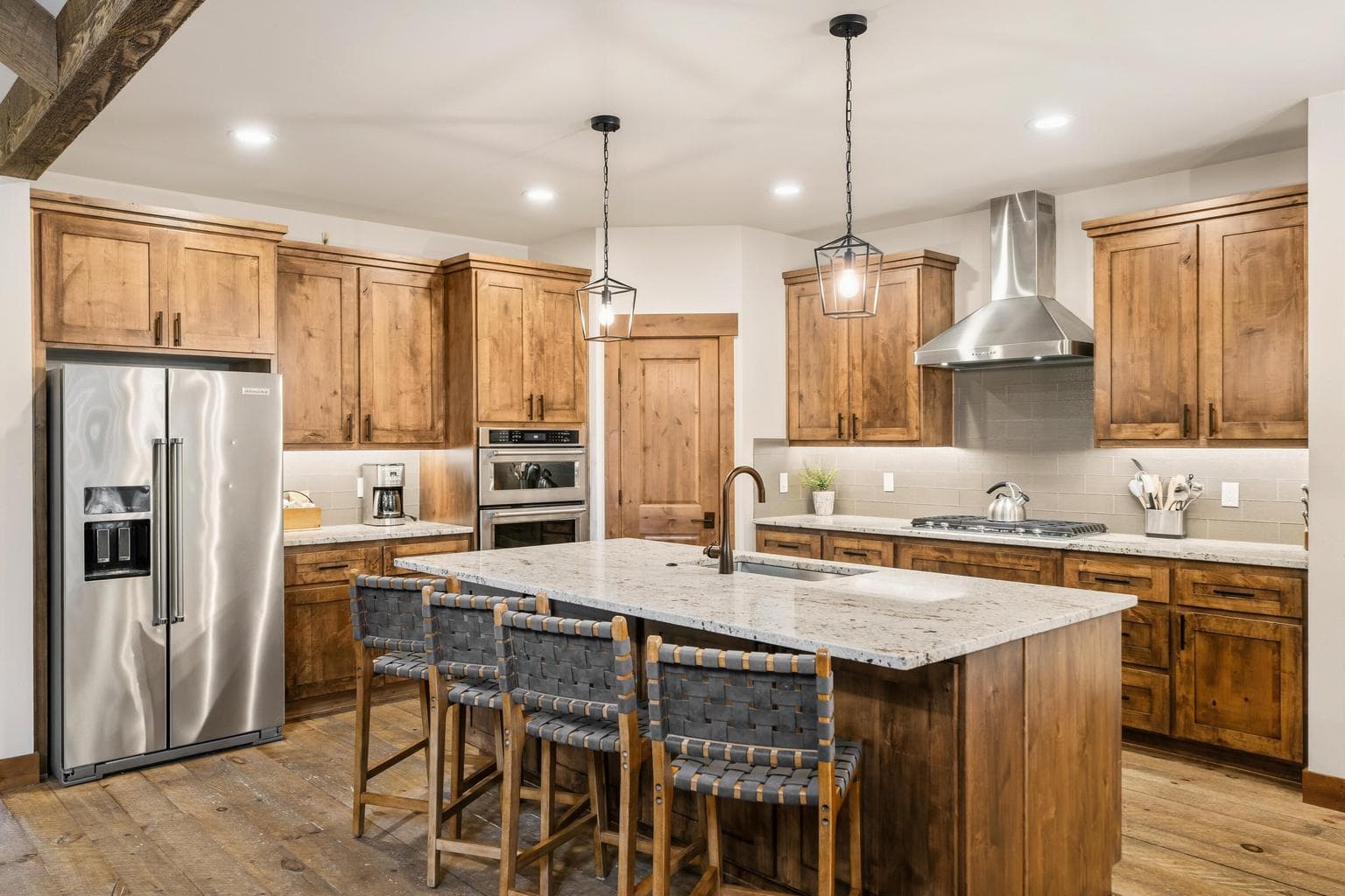 Boasting luxurious granite slab countertops, a generous island with a stylish breakfast bar, and a sleek stainless steel cooktop with a matching hood, this kitchen is a culinary playground crafted to ignite your inner master chef.