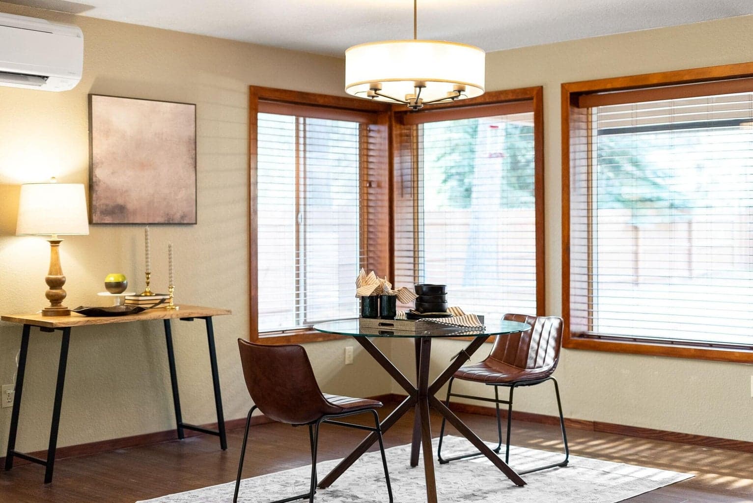 Eating area with simulated wood flooring and natural light.