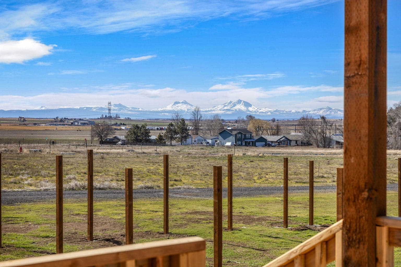 A covered rear deck perfect for outdoor seating, offering clear views of the Cascade Mountains.