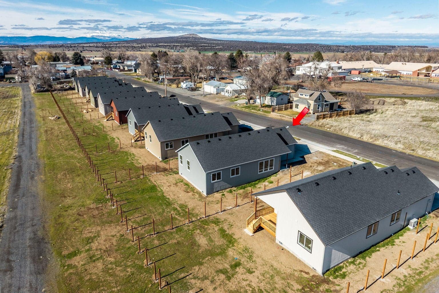 A distant aerial view showing the home's location in the quiet town of Metolius, emphasizing the open space and rural feel of Central Oregon.