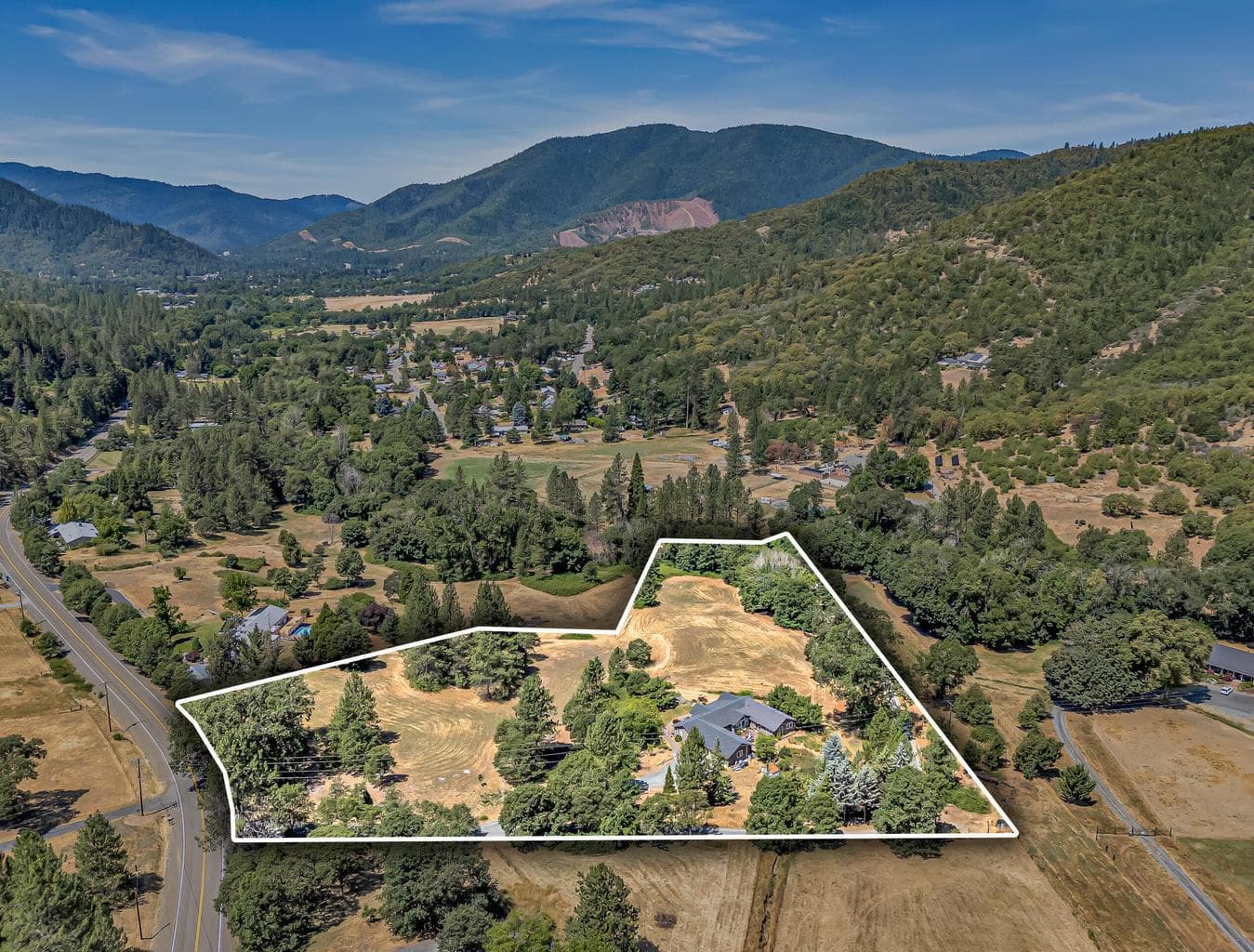 6 acres with pastures, trees, and creek frontage.
