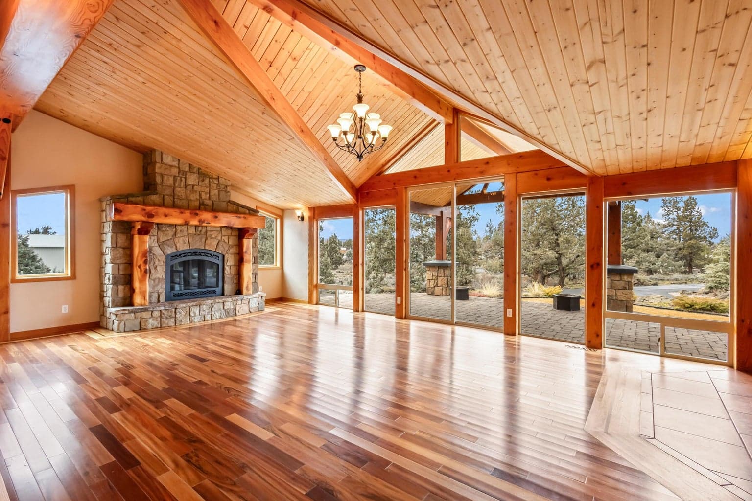Living room with extensive wood, wood inlay, beams, fireplace and windows