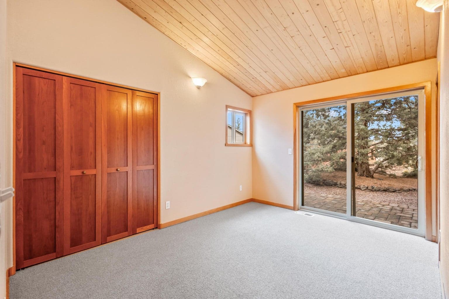 Bedroom suite 3 has a private paver patio off the slider to the rear of the home