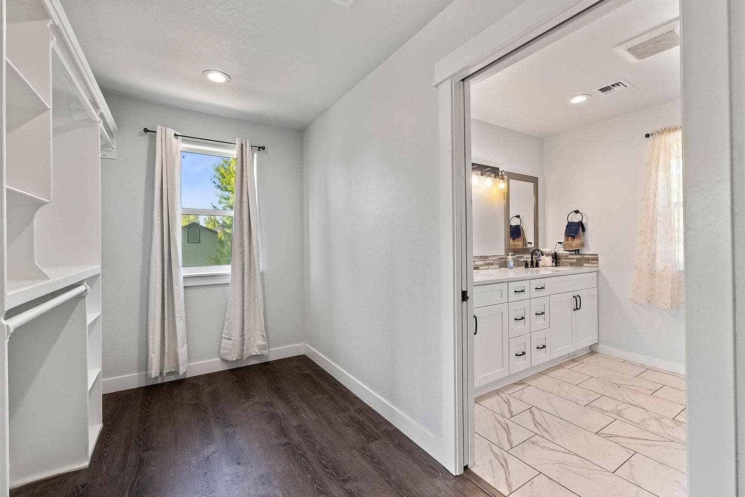 Primary walk in closet and bathroom