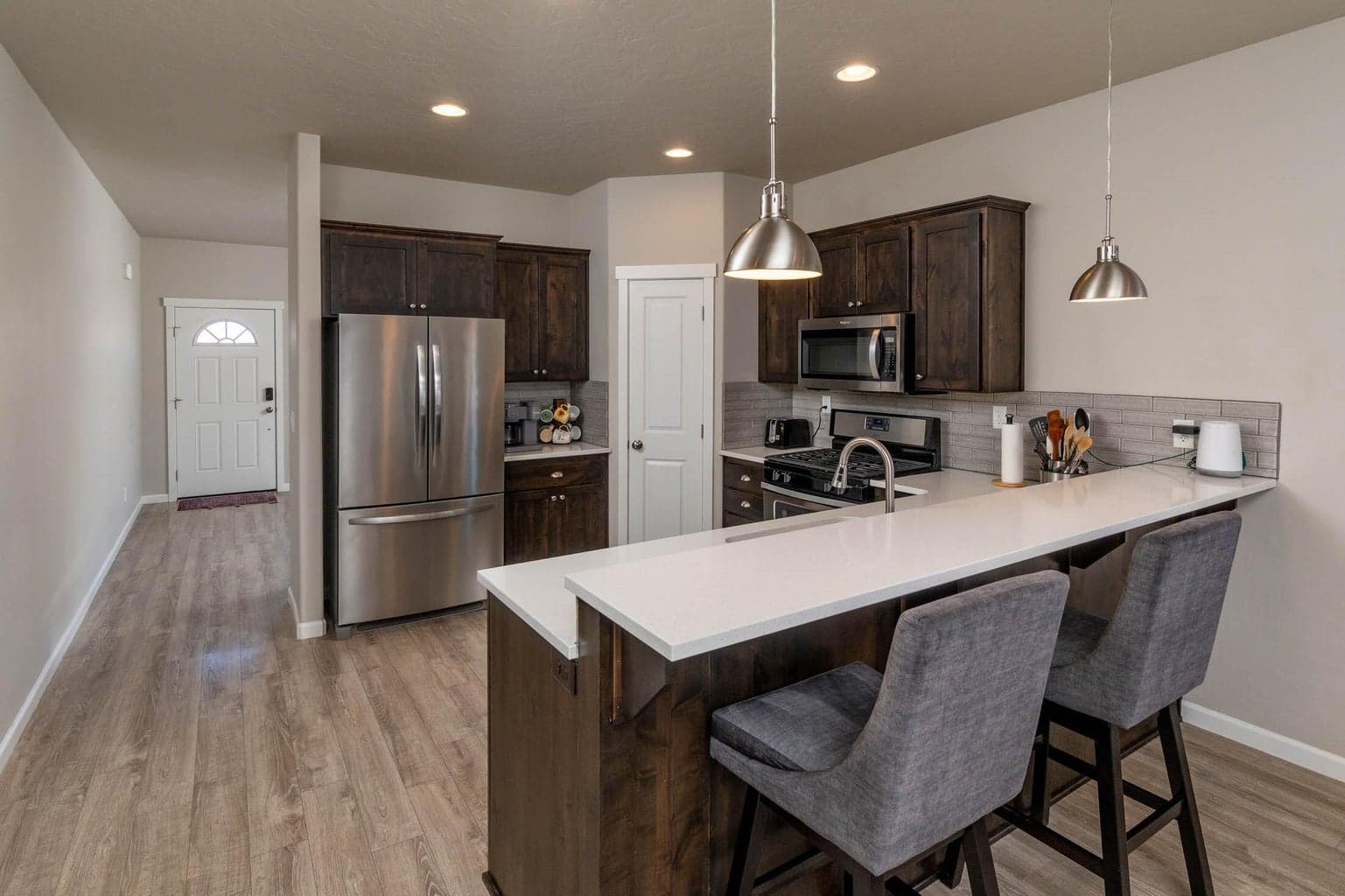Kitchen has breakfast bar and corner pantry