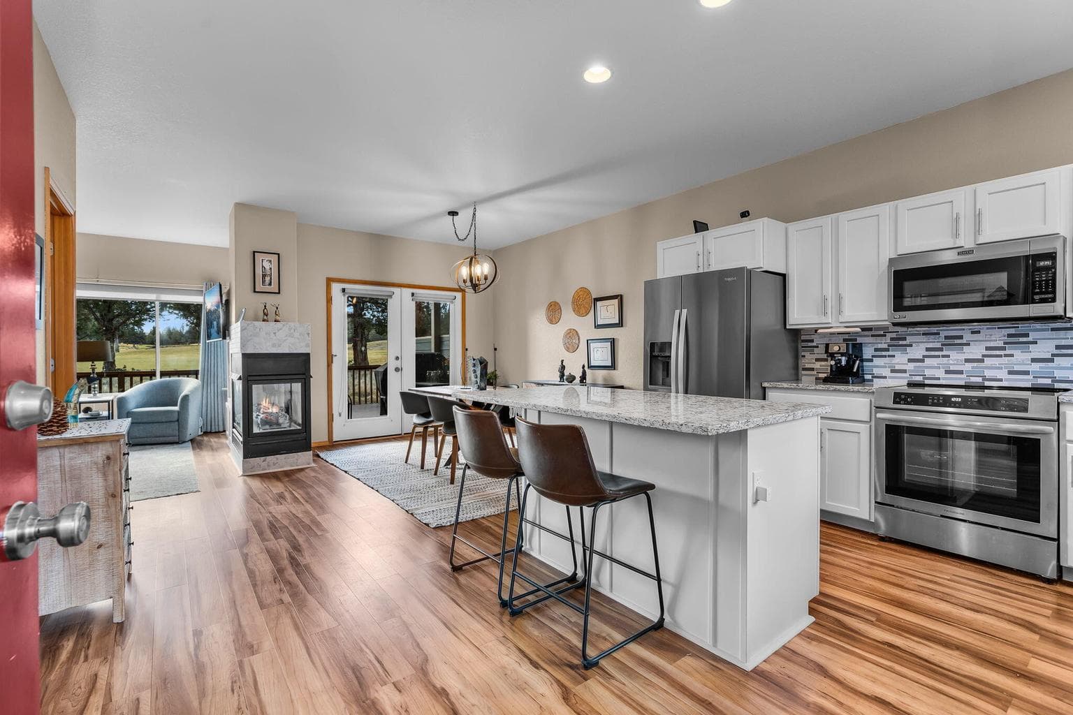 The living room features an open layout with plenty of natural light and a cozy fireplace