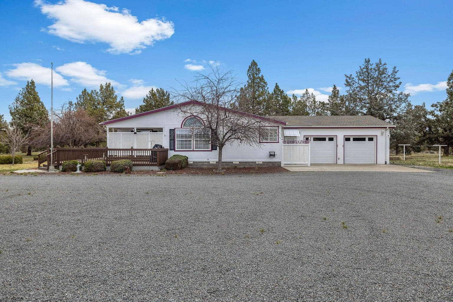 A simple, clear photo of the front of the home and the large driveway.