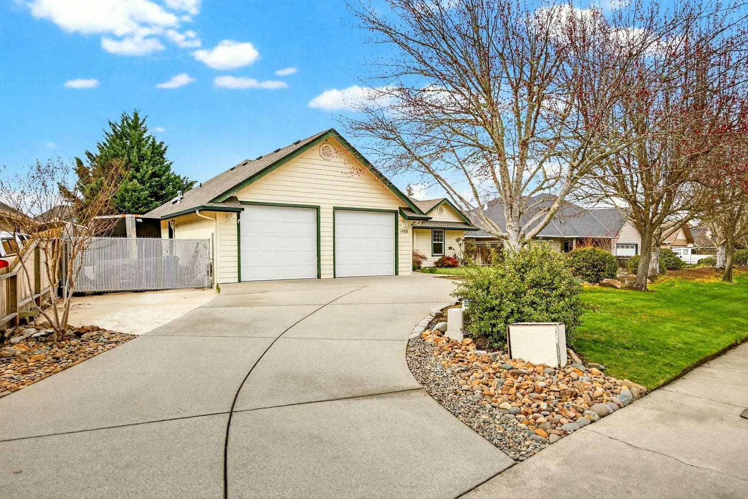 Driveway to Garage and side yard behind gate.