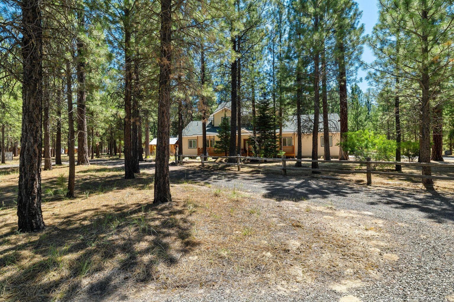 Homes sits back of road in the trees